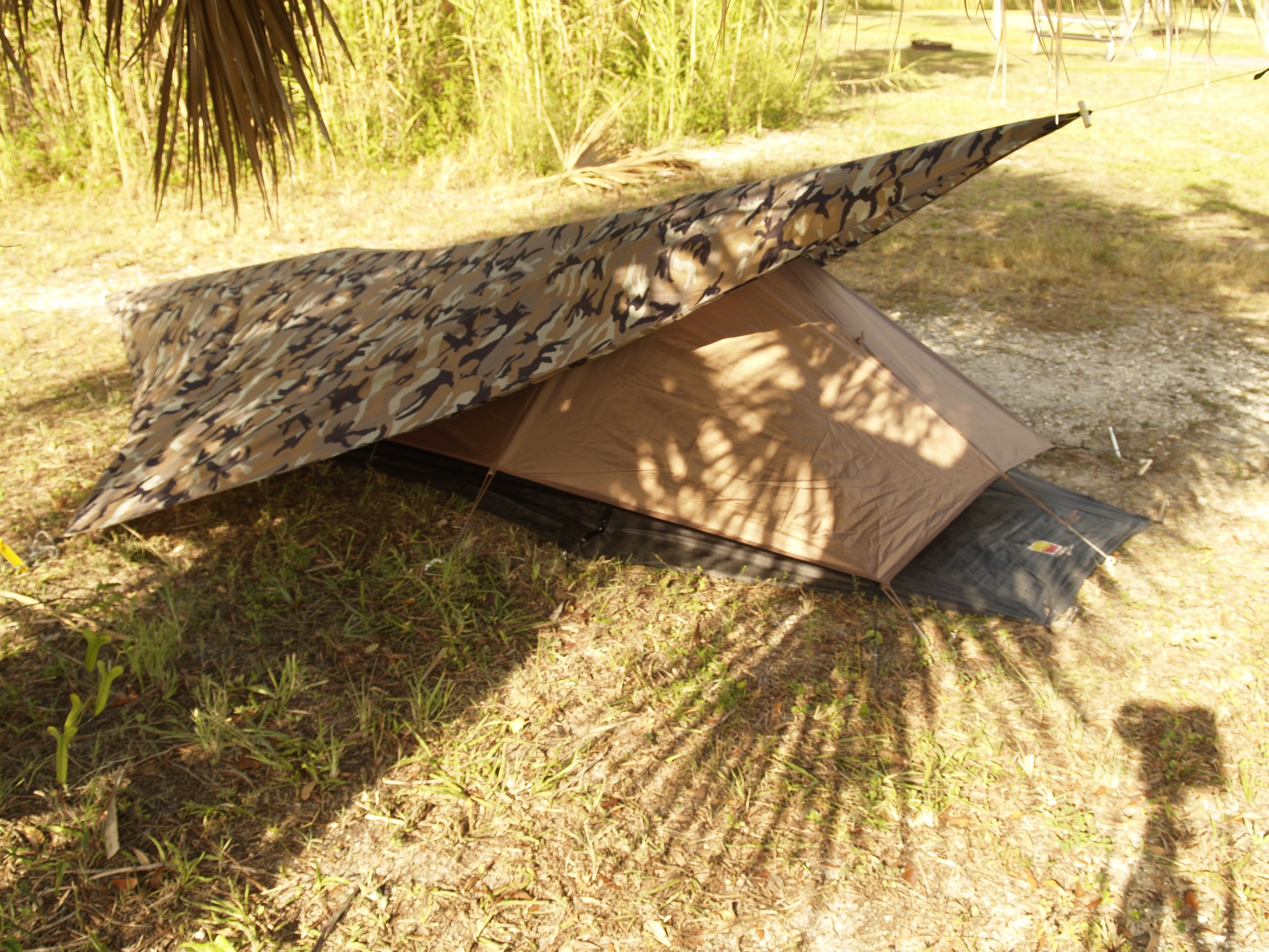 Adding an extra tarp for gear cover and additional concealment.